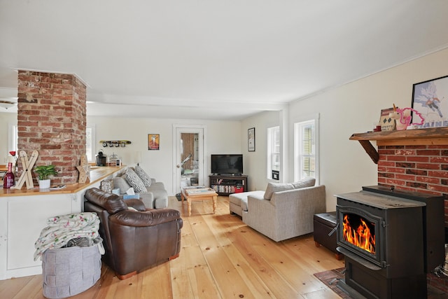 living area featuring a wood stove and light wood-style flooring