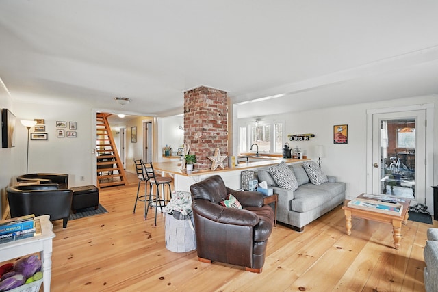 living room with hardwood / wood-style floors and stairs