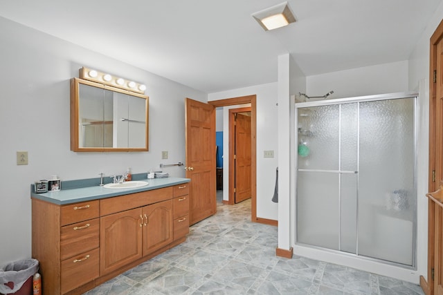 bathroom featuring a stall shower and vanity