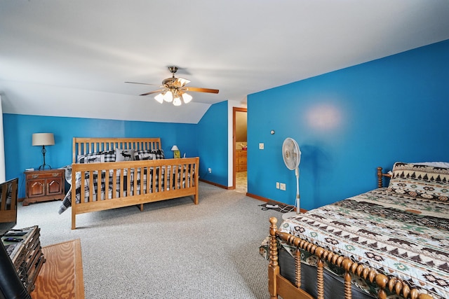 carpeted bedroom featuring lofted ceiling, baseboards, and a ceiling fan