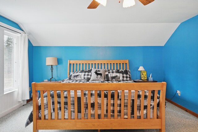 bedroom featuring carpet, vaulted ceiling, baseboards, and ceiling fan