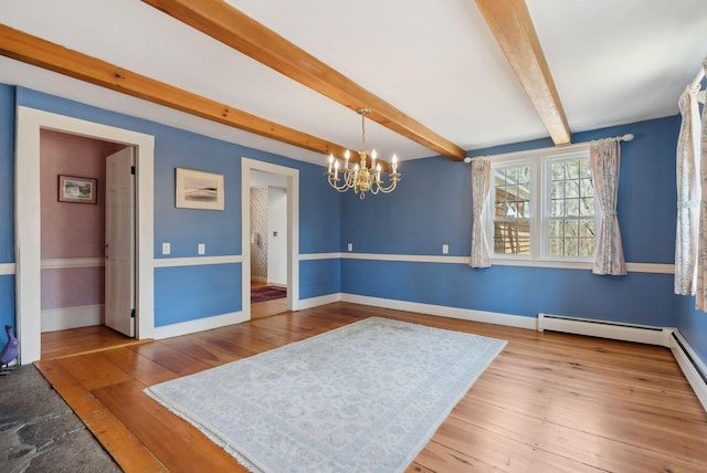 117 Youngs Ridge Rd, Acton, ME 04001 - unfurnished dining area featuring beamed ceiling, baseboards, an inviting chandelier, and wood finished floors