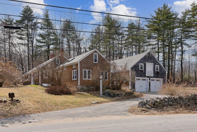 117 Youngs Ridge Rd, Acton, ME 04001 - view of front of house with a chimney, aphalt driveway, and a garage