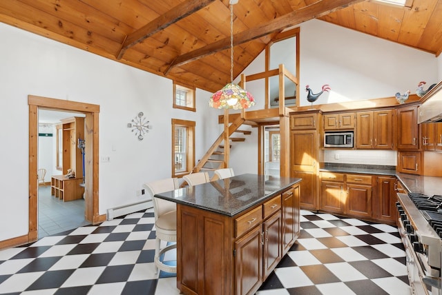 117 Youngs Ridge Rd, Acton, ME 04001 - kitchen featuring light floors, a kitchen bar, baseboard heating, appliances with stainless steel finishes, and wooden ceiling