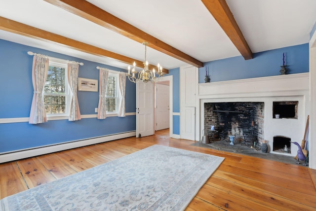 117 Youngs Ridge Rd, Acton, ME 04001 - unfurnished living room with a notable chandelier, baseboard heating, a fireplace with flush hearth, beam ceiling, and wood-type flooring