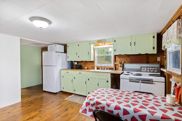 738 13th St, Acton, ME 04001 - kitchen featuring white appliances, a sink, green cabinetry, and hardwood / wood-style flooring