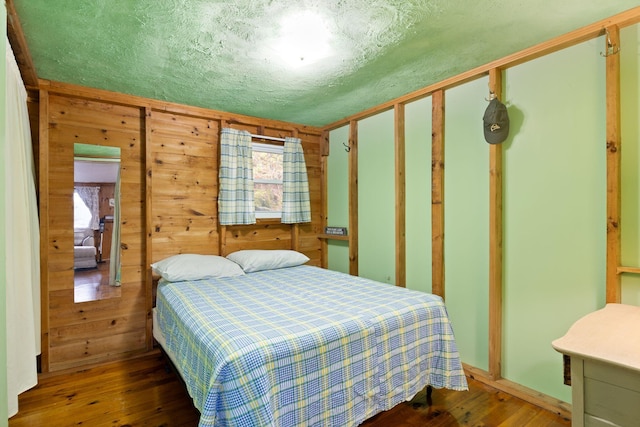 738 13th St, Acton, ME 04001 - bedroom with wood-type flooring and wood walls