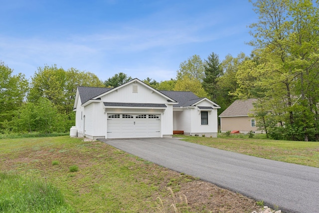 79 Colins Meadow Ln, Alfred, ME 04002 - ranch-style house featuring a garage, driveway, a front lawn, and board and batten siding
