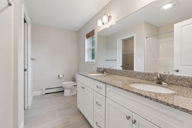 79 Colins Meadow Ln, Alfred, ME 04002 - bathroom featuring baseboard heating, double vanity, toilet, baseboards, and a shower