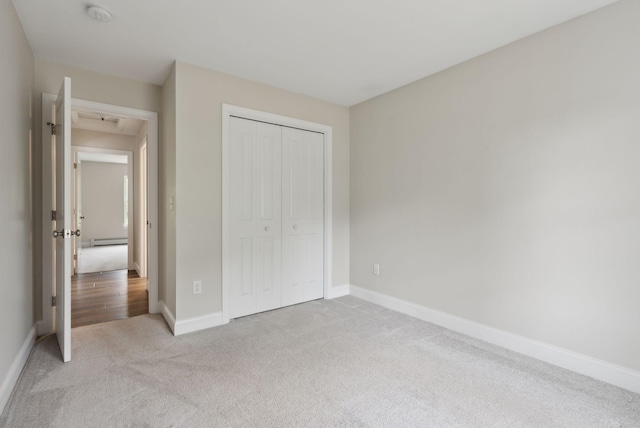 79 Colins Meadow Ln, Alfred, ME 04002 - unfurnished bedroom with light carpet, a baseboard heating unit, baseboards, and a closet