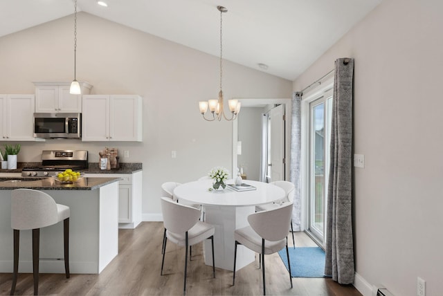79 Colins Meadow Ln, Alfred, ME 04002 - kitchen featuring stainless steel appliances, light wood-style flooring, a chandelier, healthy amount of natural light, and high vaulted ceiling