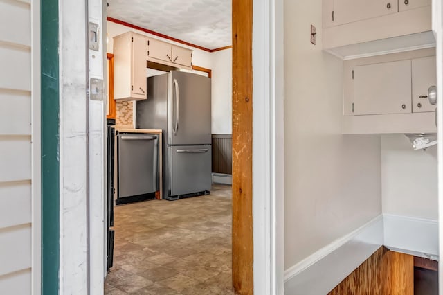 8 Sylvan Rd, Orono, ME 04473 - kitchen featuring appliances with stainless steel finishes, crown molding, and a wainscoted wall