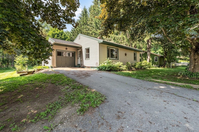 8 Sylvan Rd, Orono, ME 04473 - ranch-style house featuring a garage, asphalt driveway, and a front lawn