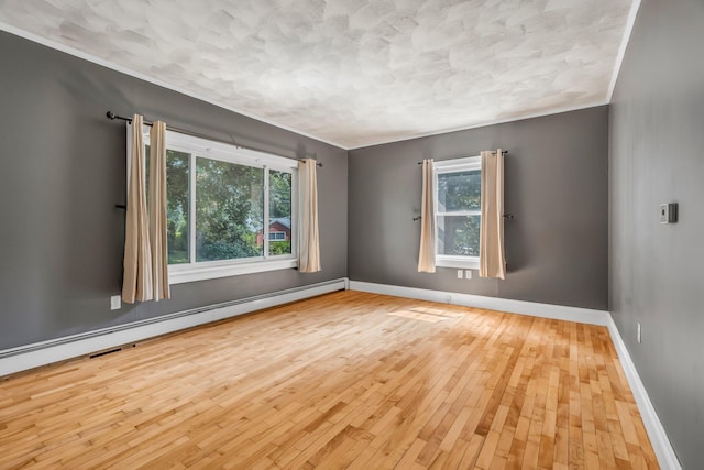 8 Sylvan Rd, Orono, ME 04473 - spare room with plenty of natural light, hardwood / wood-style flooring, baseboard heating, and a textured ceiling