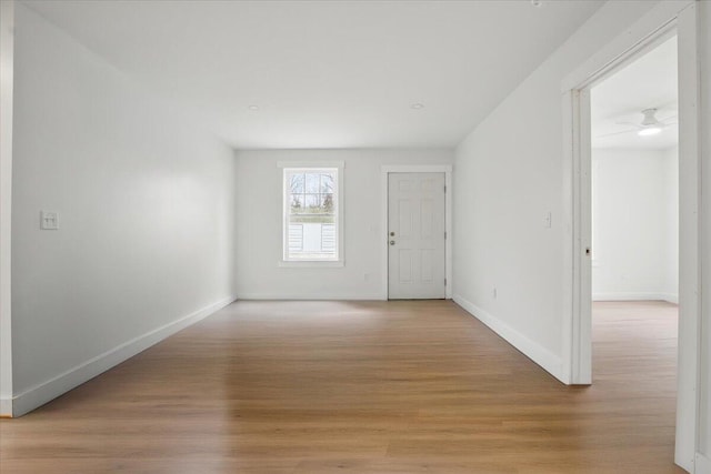 empty room with light wood finished floors and baseboards