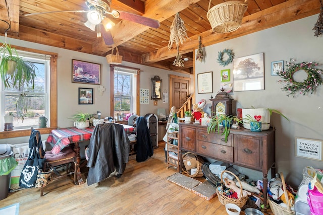 interior space featuring stairway, a ceiling fan, beamed ceiling, wood ceiling, and wood finished floors