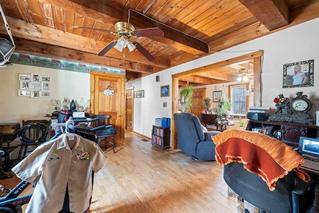 living room featuring beamed ceiling, light wood-type flooring, wooden ceiling, and ceiling fan