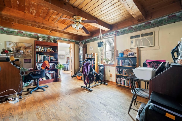 office space with ceiling fan, a wall unit AC, wooden ceiling, beam ceiling, and hardwood / wood-style flooring