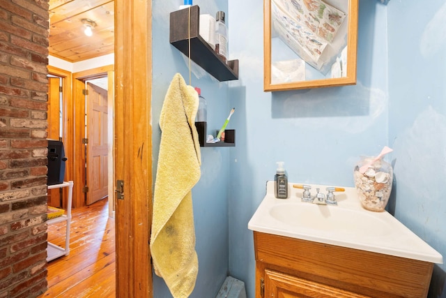 bathroom with wood ceiling, vanity, and hardwood / wood-style flooring