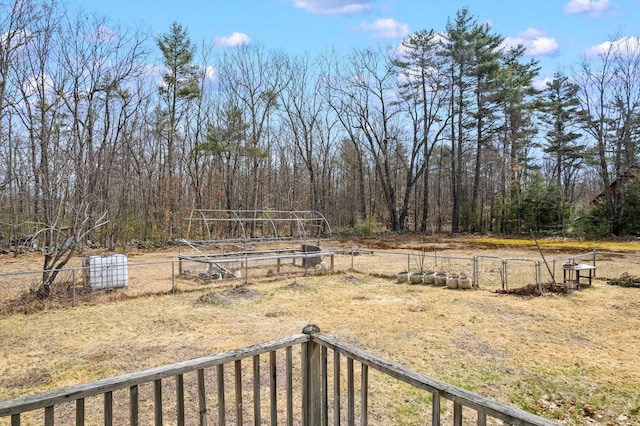 view of yard featuring a vegetable garden, fence, and a gate