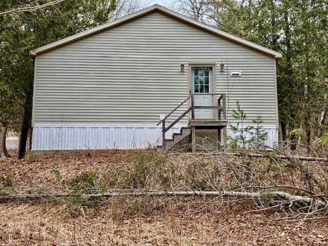 back of house with entry steps
