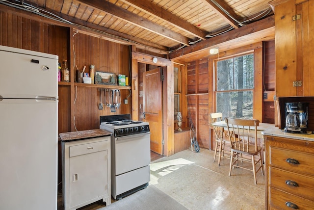 34 Jordan Shore Dr, Poland, ME 04274 - kitchen with wooden ceiling, beam ceiling, white appliances, brown cabinets, and wooden walls