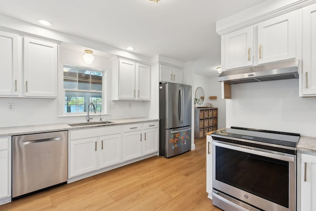 34 Jordan Shore Dr, Poland, ME 04274 - kitchen featuring under cabinet range hood, a sink, light wood-type flooring, appliances with stainless steel finishes, and white cabinetry