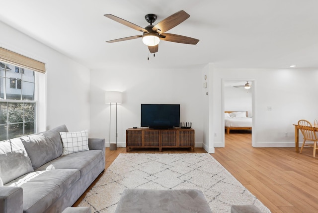 34 Jordan Shore Dr, Poland, ME 04274 - living area featuring baseboards, a ceiling fan, and light wood-style floors
