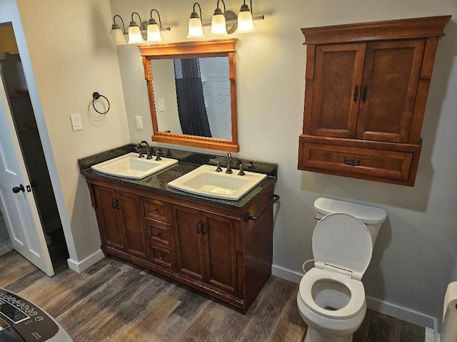 153 Elm St, Newport, ME 04953 - full bathroom featuring baseboards, wood finished floors, double vanity, and toilet