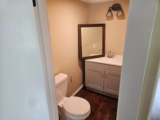 153 Elm St, Newport, ME 04953 - bathroom featuring toilet, vanity, wood finished floors, and baseboards