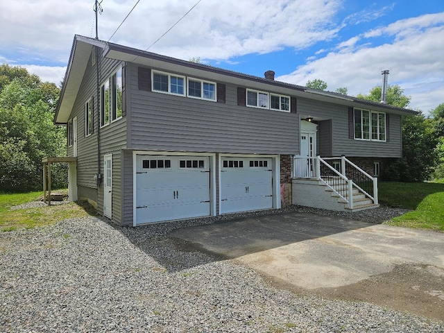 153 Elm St, Newport, ME 04953 - bi-level home featuring driveway and a garage