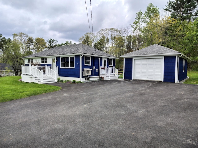 90 Whig St, Winterport, ME 04496 - ranch-style home with an outbuilding, a detached garage, a shingled roof, driveway, and a front lawn