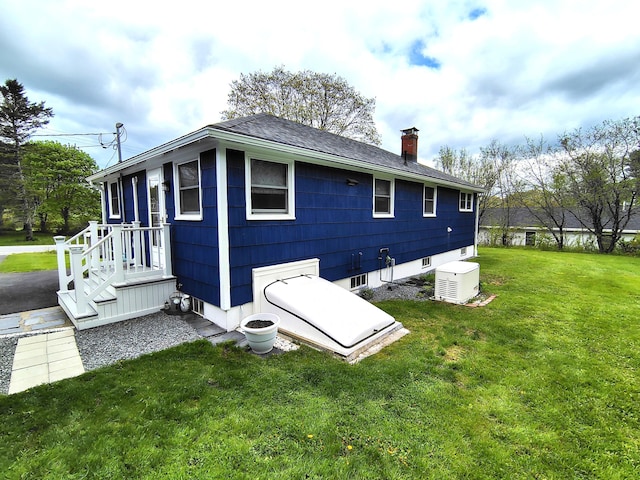 90 Whig St, Winterport, ME 04496 - rear view of property with a chimney, a yard, and a shingled roof