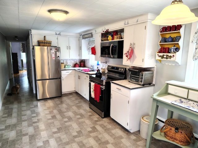 90 Whig St, Winterport, ME 04496 - kitchen featuring appliances with stainless steel finishes, open shelves, white cabinetry, and light countertops