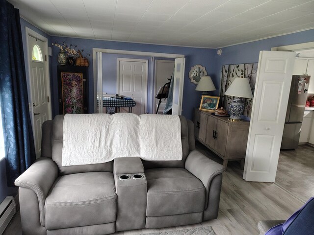 90 Whig St, Winterport, ME 04496 - living room with baseboard heating and light wood finished floors
