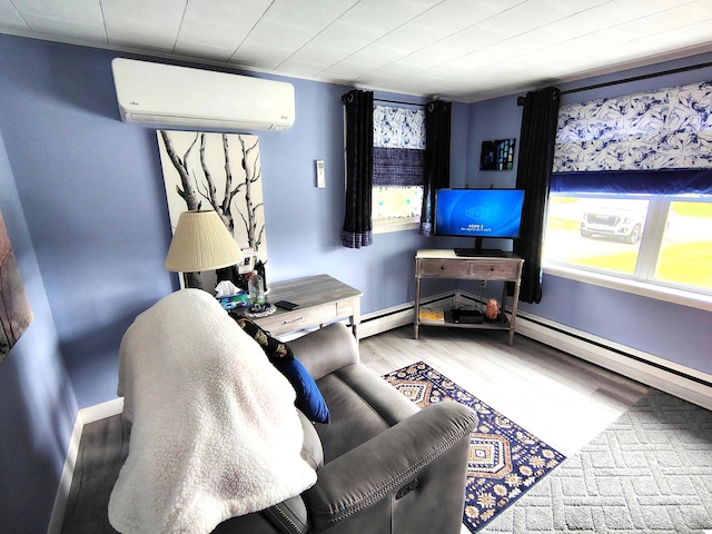 90 Whig St, Winterport, ME 04496 - living area with an AC wall unit, wood finished floors, baseboards, and a baseboard radiator