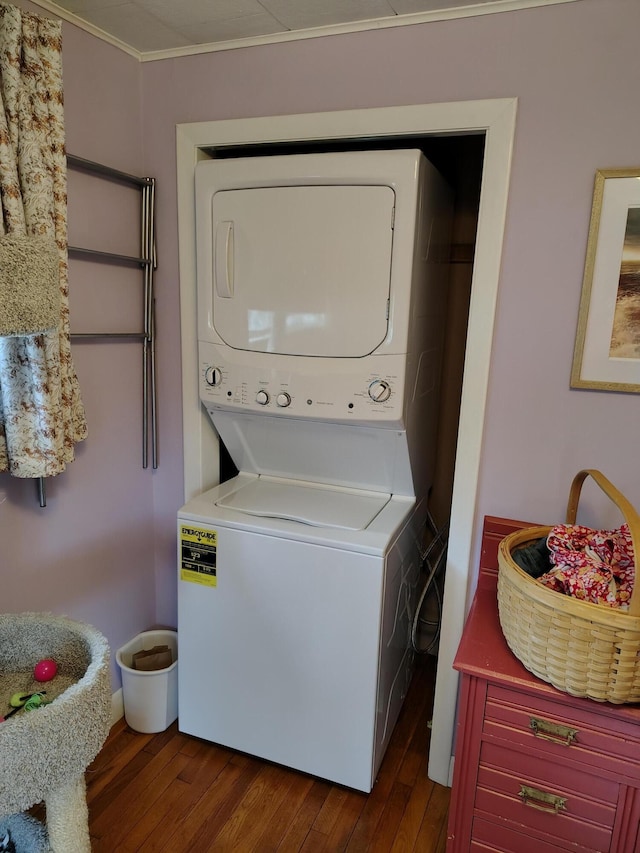 90 Whig St, Winterport, ME 04496 - laundry room with estacked washer and dryer, dark wood-type flooring, and crown molding