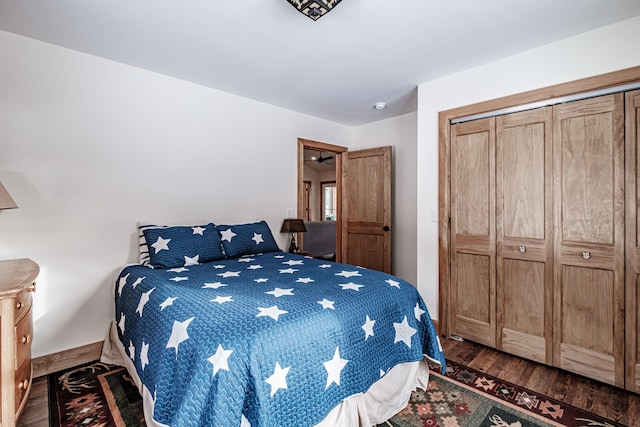 bedroom with a closet and dark wood finished floors