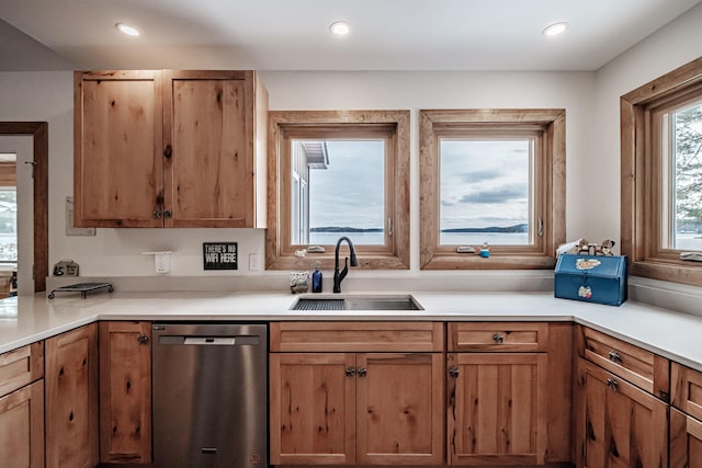kitchen featuring dishwasher, recessed lighting, a sink, and light countertops