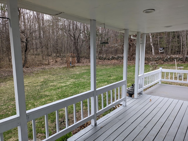 wooden deck with a yard and covered porch