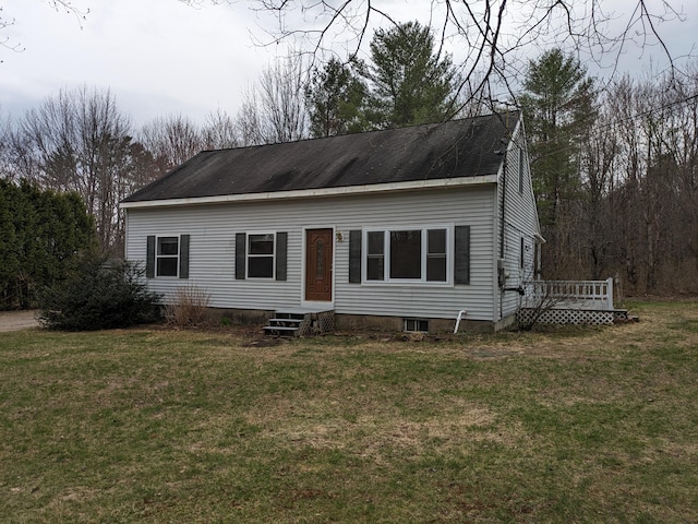 view of front facade featuring a wooden deck and a front yard