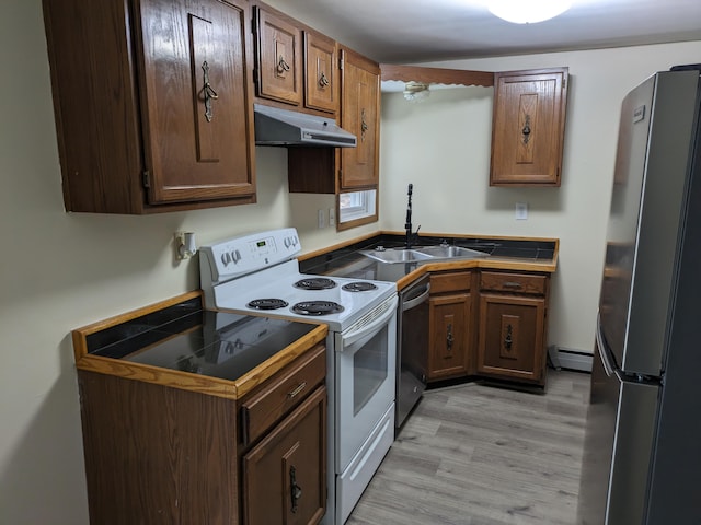 kitchen with a baseboard heating unit, a sink, under cabinet range hood, light wood-style floors, and appliances with stainless steel finishes