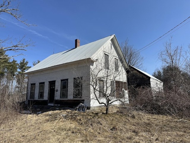 241 Sanborn Rd, Acton, ME 04001 - view of side of property with a chimney and metal roof