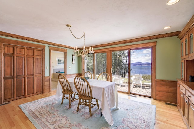 dining space featuring wainscoting, recessed lighting, a notable chandelier, and light wood-type flooring
