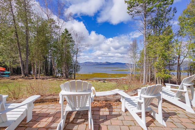 view of patio featuring a water and mountain view
