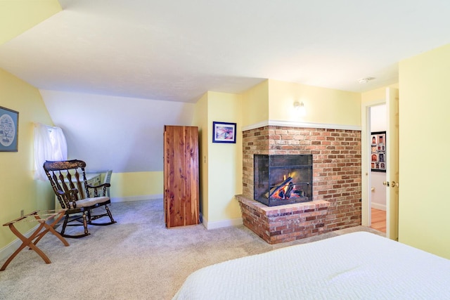 carpeted bedroom with baseboards and a brick fireplace