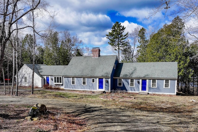 cape cod-style house with a chimney