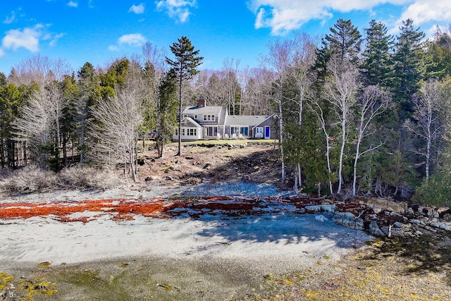 exterior space featuring a wooded view