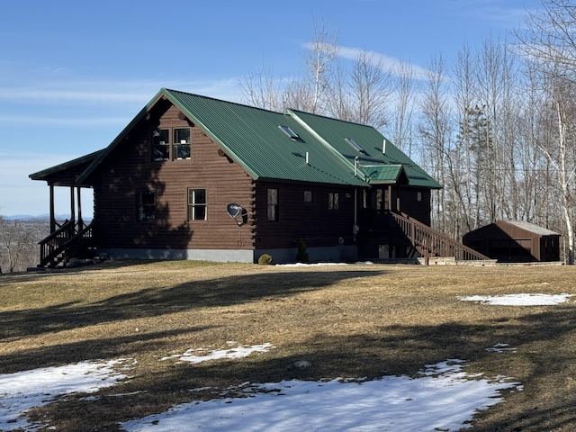 1083 N Rd, Ripley, ME 04930 - snow covered rear of property featuring metal roof and log exterior