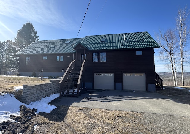 1083 N Rd, Ripley, ME 04930 - rear view of property featuring an attached garage, metal roof, aphalt driveway, and stairs
